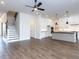 Spacious area featuring hardwood floors, a ceiling fan and a stylish kitchen at 1013 Coldspring Circle, Durham, NC 27705