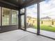 Covered porch featuring a concrete floor, screened windows, and a scenic backyard view at 1013 Coldspring Circle, Durham, NC 27705
