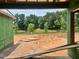 Construction site featuring an expansive nature view with a lake, captured from inside the garage at 1013 Coldspring Circle, Durham, NC 27705