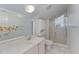 Bright bathroom featuring a vanity, large mirror, shower, and stylish white finishes at 103 Pony Express Cv, Louisburg, NC 27549