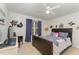 Bright bedroom with stylish patterned bedding, ceiling fan, and window at 103 Pony Express Cv, Louisburg, NC 27549