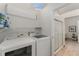 Bright laundry room with a washer and dryer set, plus a peek at the shower room at 103 Pony Express Cv, Louisburg, NC 27549