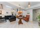 Elegant living room featuring tile floors, a chandelier, and cozy seating area at 103 Pony Express Cv, Louisburg, NC 27549