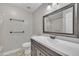 Well-lit bathroom with a sleek vanity, framed mirror, and towel rack at 105 Poplar Dr. Dr, Clayton, NC 27520