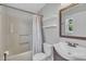 Bathroom featuring a white bathtub, toilet and sink with a wood framed mirror and window at 105 Poplar Dr. Dr, Clayton, NC 27520