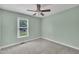 Bright bedroom with soft carpet, ceiling fan, and a window providing natural light at 105 Poplar Dr. Dr, Clayton, NC 27520