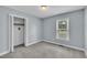 Cozy bedroom with soft carpet, a window with blinds, and closet for storage at 105 Poplar Dr. Dr, Clayton, NC 27520