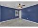 Modern bedroom featuring plush carpet, a ceiling fan, and a window at 105 Poplar Dr. Dr, Clayton, NC 27520