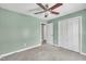 Serene bedroom featuring soft carpet, a ceiling fan, and a closet for storage at 105 Poplar Dr. Dr, Clayton, NC 27520