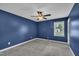 Stylish bedroom with plush carpet, a ceiling fan, and window with natural light at 105 Poplar Dr. Dr, Clayton, NC 27520