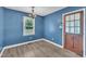 Cozy dining area with wood-look floors, a bright window, and an elegant light fixture at 105 Poplar Dr. Dr, Clayton, NC 27520