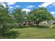 Expansive front yard with mature trees and manicured lawn creating a welcoming curb appeal at 105 Poplar Dr. Dr, Clayton, NC 27520