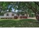 Charming single-story home with a well-maintained lawn, mature trees, and a convenient covered carport at 105 Poplar Dr. Dr, Clayton, NC 27520