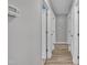Hallway featuring wood-look flooring and several white doors at 105 Poplar Dr. Dr, Clayton, NC 27520