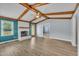 Bright living room featuring vaulted ceilings, exposed wood beams, and a cozy fireplace at 105 Poplar Dr. Dr, Clayton, NC 27520