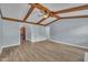 Living room featuring vaulted ceilings, exposed wood beams, and neutral wall paint at 105 Poplar Dr. Dr, Clayton, NC 27520