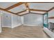 Open living room with vaulted ceilings, exposed wood beams, and a charming fireplace at 105 Poplar Dr. Dr, Clayton, NC 27520