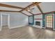 Open living room with vaulted ceilings, exposed wood beams, and a brick fireplace at 105 Poplar Dr. Dr, Clayton, NC 27520