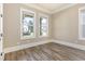 Neutral bedroom featuring hardwood floors and large windows for natural light at 1131 Lowland St, Apex, NC 27523