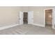Bedroom with plush carpet and two open doors to the hall and bathroom at 1131 Lowland St, Apex, NC 27523