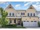 Inviting two-story home with a charming front porch and a well-manicured lawn, featuring a two-car garage at 1131 Lowland St, Apex, NC 27523