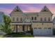 Inviting two-story home with a charming front porch and a well-manicured lawn, featuring a two-car garage at 1131 Lowland St, Apex, NC 27523