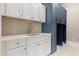 Convenient laundry room featuring plenty of counter space and custom built-in cabinets at 1131 Lowland St, Apex, NC 27523