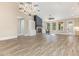Spacious living room featuring wood-look floors, a cozy fireplace, and large windows for natural light at 1131 Lowland St, Apex, NC 27523