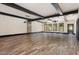 Spacious open-concept living room with wooden floors, exposed beams, and plenty of windows at 1131 Lowland St, Apex, NC 27523