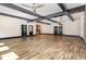 A large open space with wood-look flooring, accent lighting and access to a bar at 1131 Lowland St, Apex, NC 27523