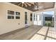 Relaxing covered porch with ceiling fans, a wood floor, and access to the house through a glass door at 1131 Lowland St, Apex, NC 27523