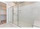 Bathroom showcasing tiled shower with a glass door and built-in shelving at 1131 Lowland St, Apex, NC 27523