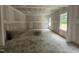 Unfinished living room space illuminated by natural light streaming through the windows at 115 Mildred Place, Broadway, NC 27505