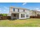 Landscaped backyard featuring a lawn, privacy fence, and screened porch with a view of the home's rear at 116 Hayfield Dr, Lillington, NC 27546
