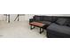 Cozy basement area with plush carpeting, and a comfortable dark gray sectional, perfect for relaxation at 116 Hayfield Dr, Lillington, NC 27546