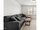 Basement area with plush carpeting, a large sectional sofa, and natural light, perfect for relaxation at 116 Hayfield Dr, Lillington, NC 27546