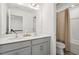 Bright bathroom featuring a double sink vanity and shower at 116 Hayfield Dr, Lillington, NC 27546