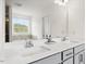 Bathroom featuring double sink vanity and large mirror at 116 Hayfield Dr, Lillington, NC 27546