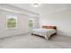 Bright bedroom features two large windows and neutral color palette at 116 Hayfield Dr, Lillington, NC 27546