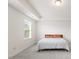 Bright bedroom features a large window and neutral color palette at 116 Hayfield Dr, Lillington, NC 27546