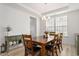 The dining area features wood floors, a modern chandelier, and plenty of natural light at 116 Hayfield Dr, Lillington, NC 27546