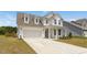 Beautiful two-story home with an attached two-car garage and well-maintained front lawn at 116 Hayfield Dr, Lillington, NC 27546