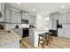 Bright kitchen featuring granite countertops, stainless steel appliances, and a convenient kitchen island with bar seating at 116 Hayfield Dr, Lillington, NC 27546
