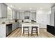Well-equipped kitchen boasts stone countertops, stainless steel appliances, and a central island at 116 Hayfield Dr, Lillington, NC 27546