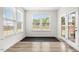 Bright sunroom featuring large windows, a door to the outdoors, and neutral flooring at 116 Hayfield Dr, Lillington, NC 27546
