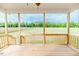 Relaxing screened-in back porch perfect for enjoying the outdoors with views of the fenced yard and trees at 117 Knight Rd Rd, Broadway, NC 27505
