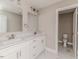 Bright bathroom featuring double sinks, white marble floors, and a separate toilet room at 117 Knight Rd Rd, Broadway, NC 27505