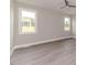Bright bedroom with natural light offers neutral walls and updated gray wood-look flooring at 117 Knight Rd Rd, Broadway, NC 27505