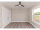 Neutral bedroom featuring hardwood floors, a ceiling fan, a window, and a double-door closet at 117 Knight Rd Rd, Broadway, NC 27505