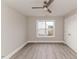 Comfortable bedroom features hardwood floors, a ceiling fan, a window with a view, and a closet at 117 Knight Rd Rd, Broadway, NC 27505